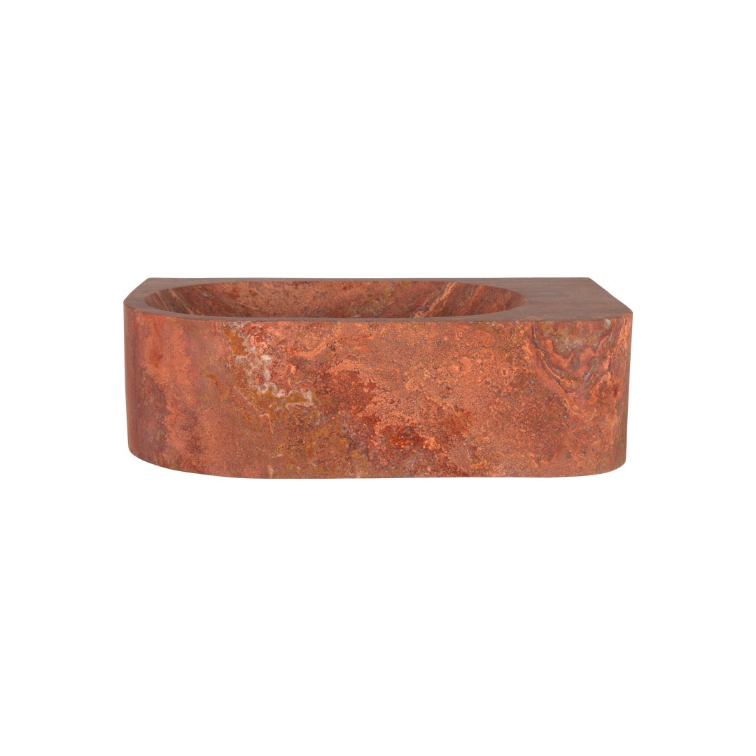 Red stone basin on white background, front view.