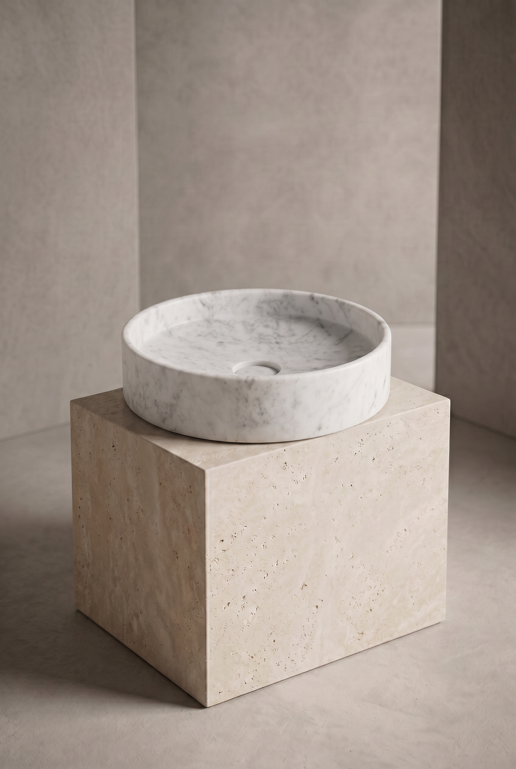 Marble basin on a beige pedestal against a neutral wall