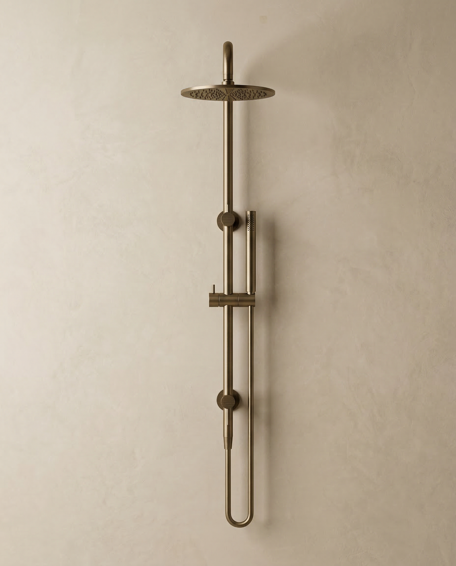 Antique Brass shower head and control handle on a beige wall