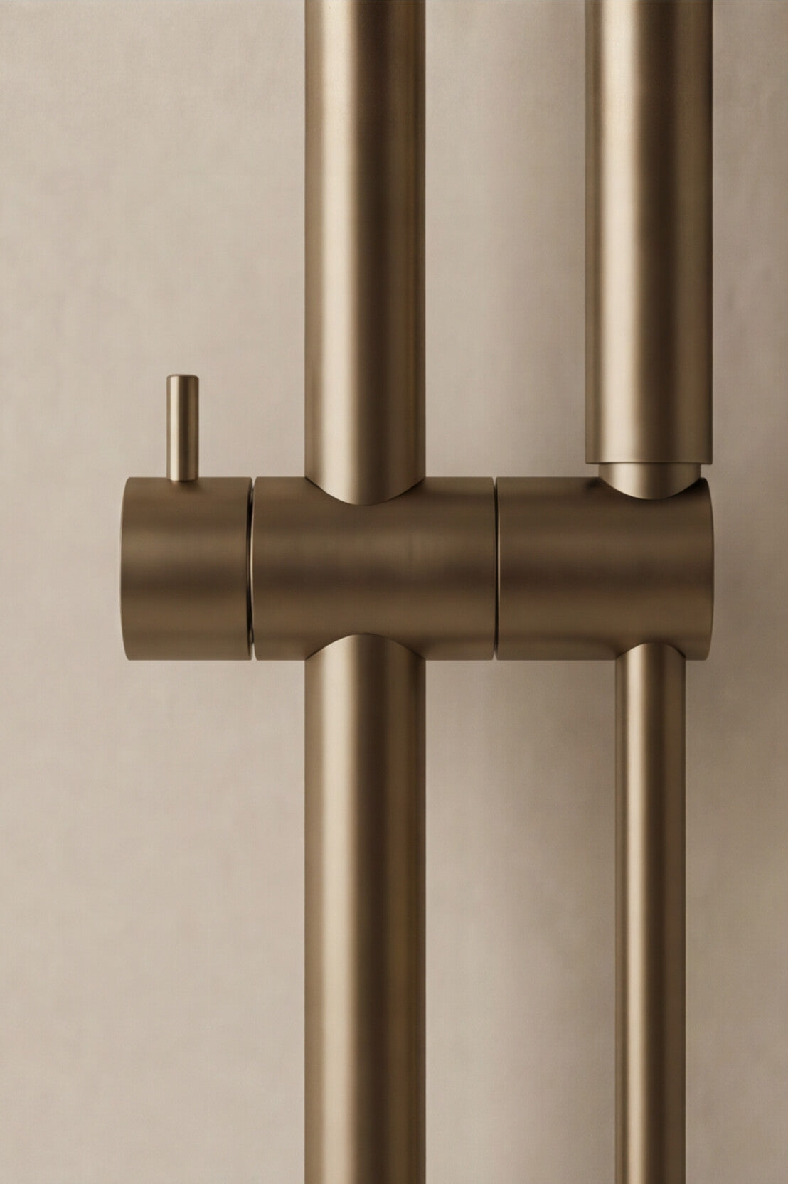 Antique brass shower set detail on a beige background