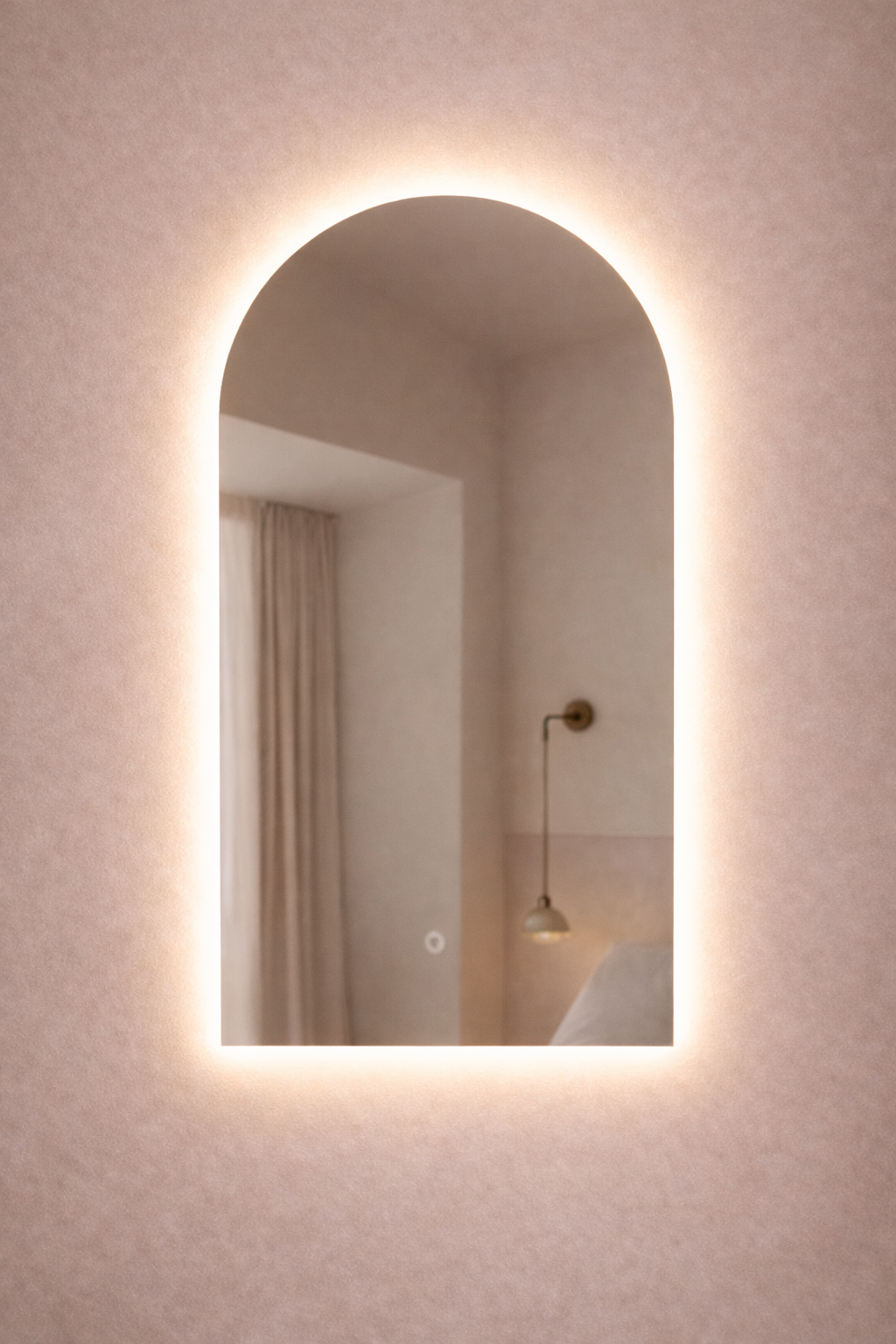 Arch-shaped mirror with illuminated frame on a wall
