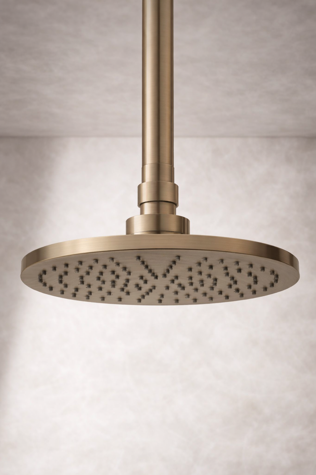 Antique brass shower head on a neutral background