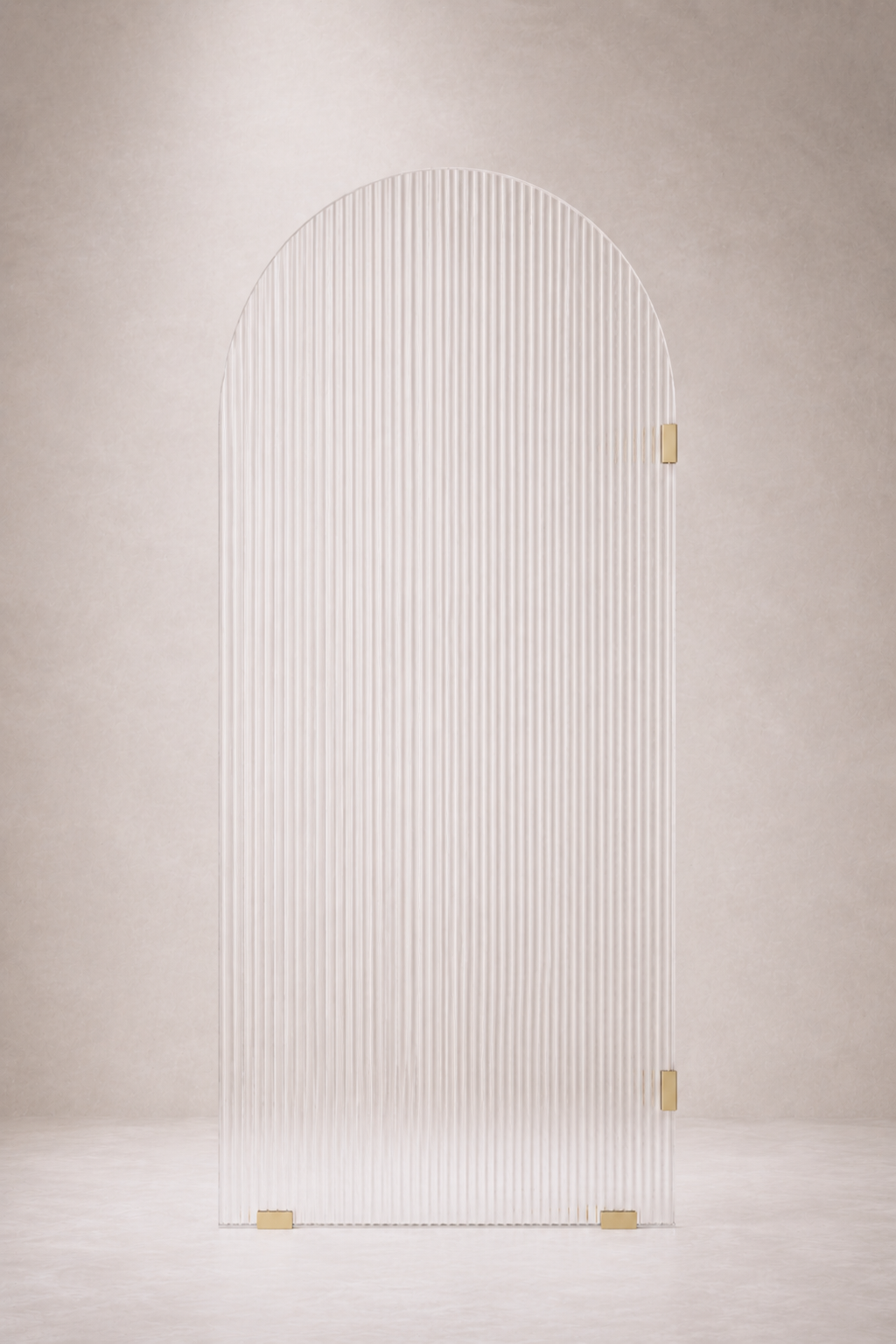 Glass fluted arched shower screen with gold hardware on a beige wall