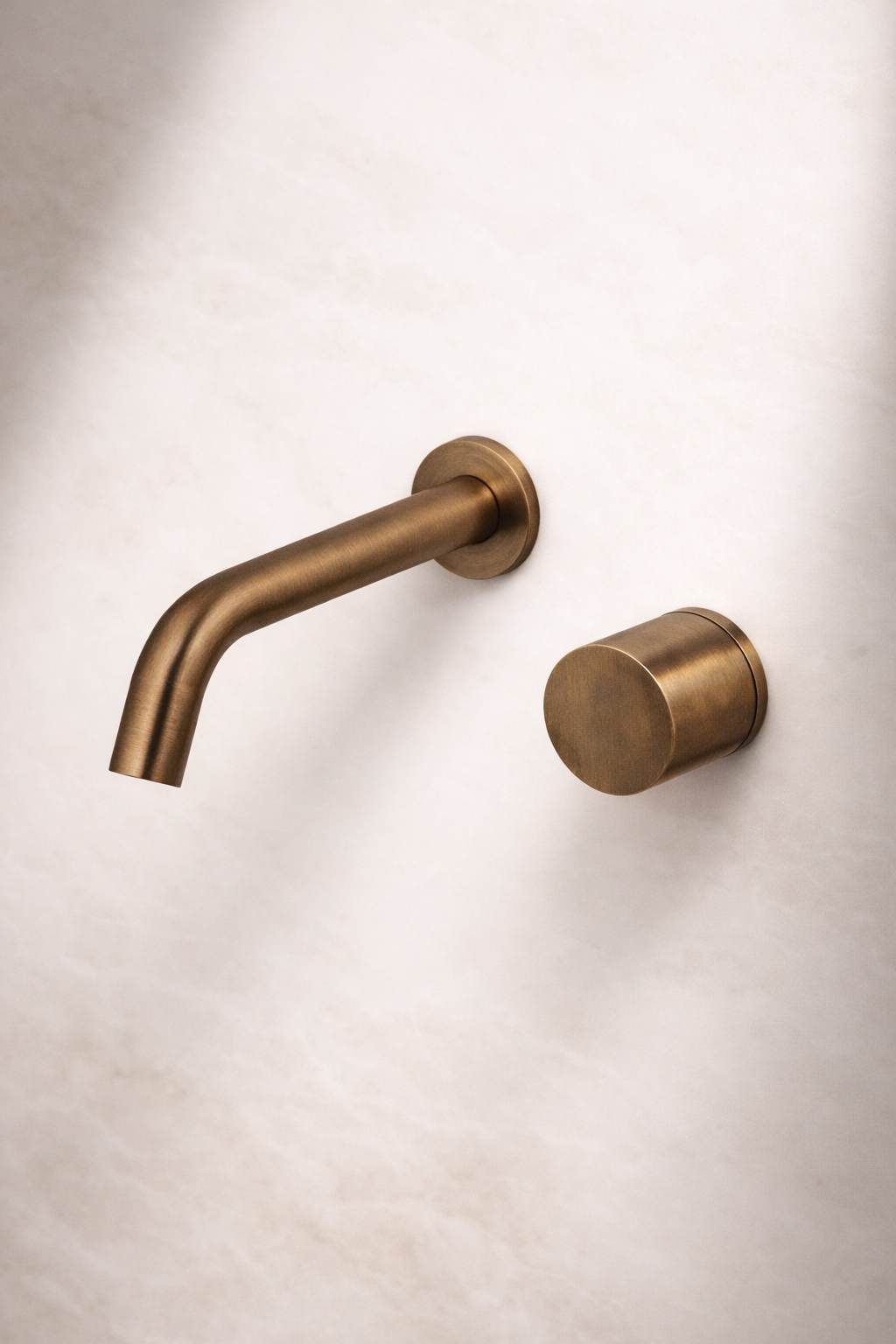 Antique Brass wall-mounted faucet on a white wall