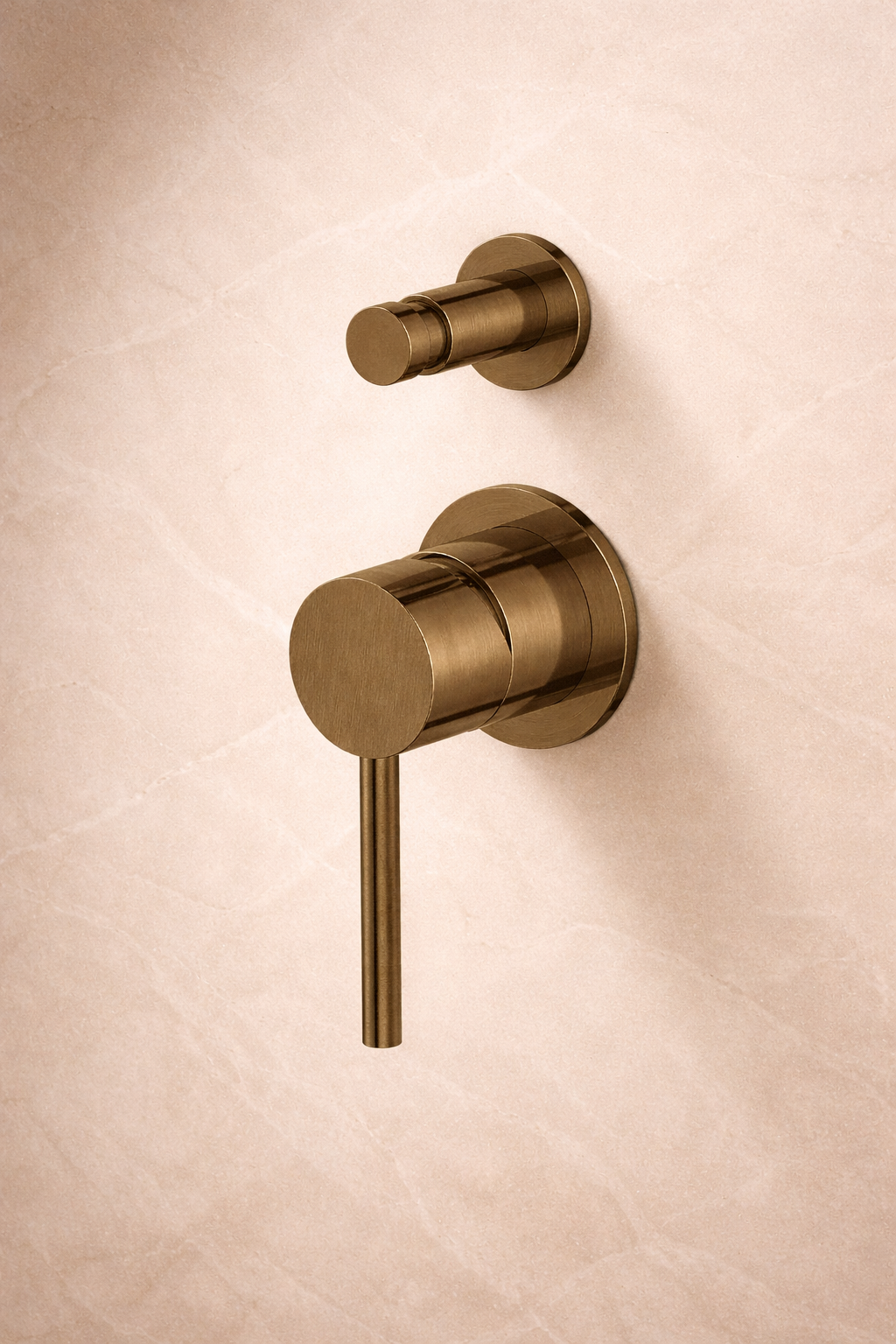 Antique brass wall-mounted faucet and handle on a beige wall